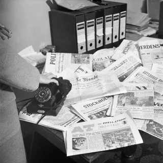 A newspaper newsroom with desks and editorial equipment