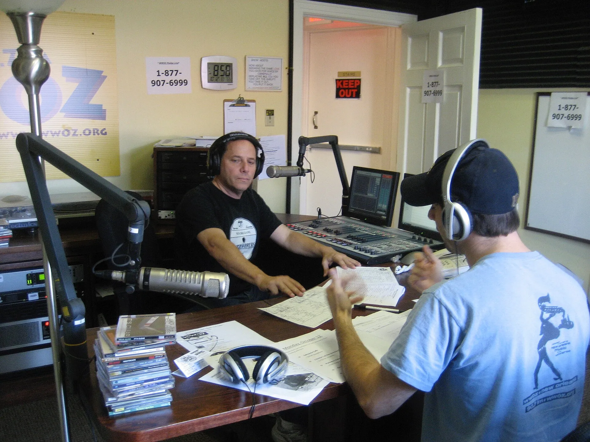 A radio studio microphone and broadcast desk