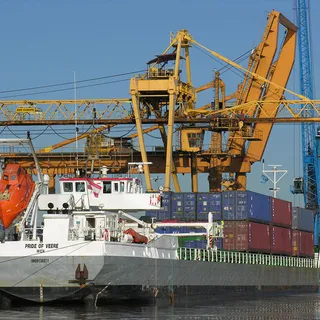 Shipping containers and cranes at a busy port