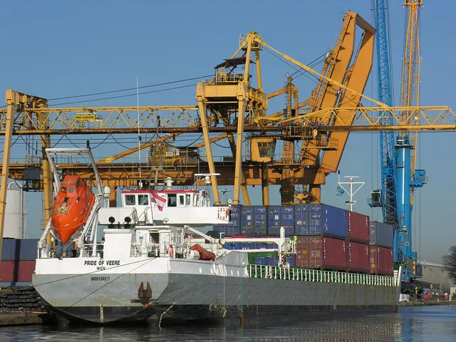 Shipping containers and cranes at a busy port