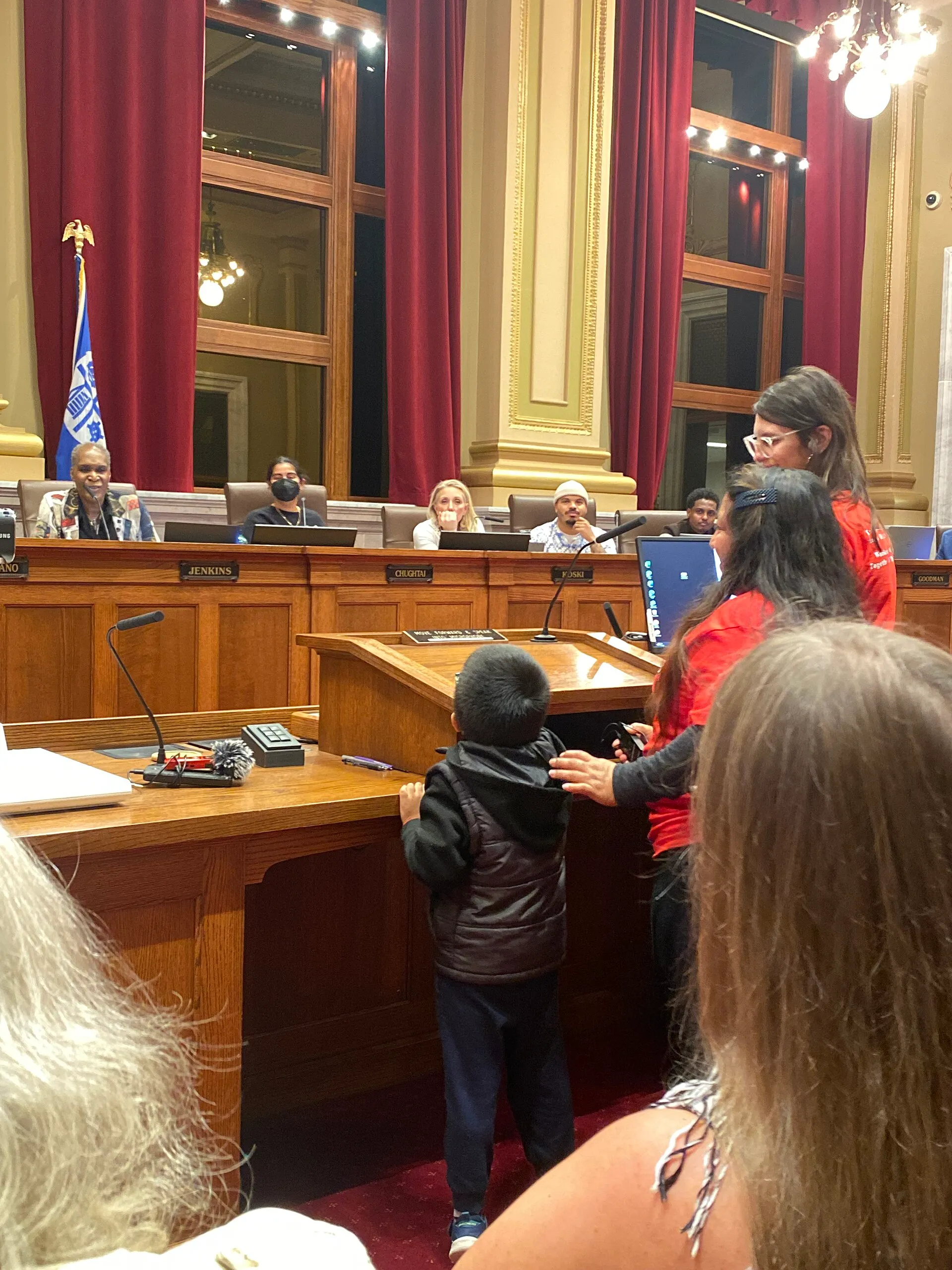 A city council chamber prepared for a public meeting
