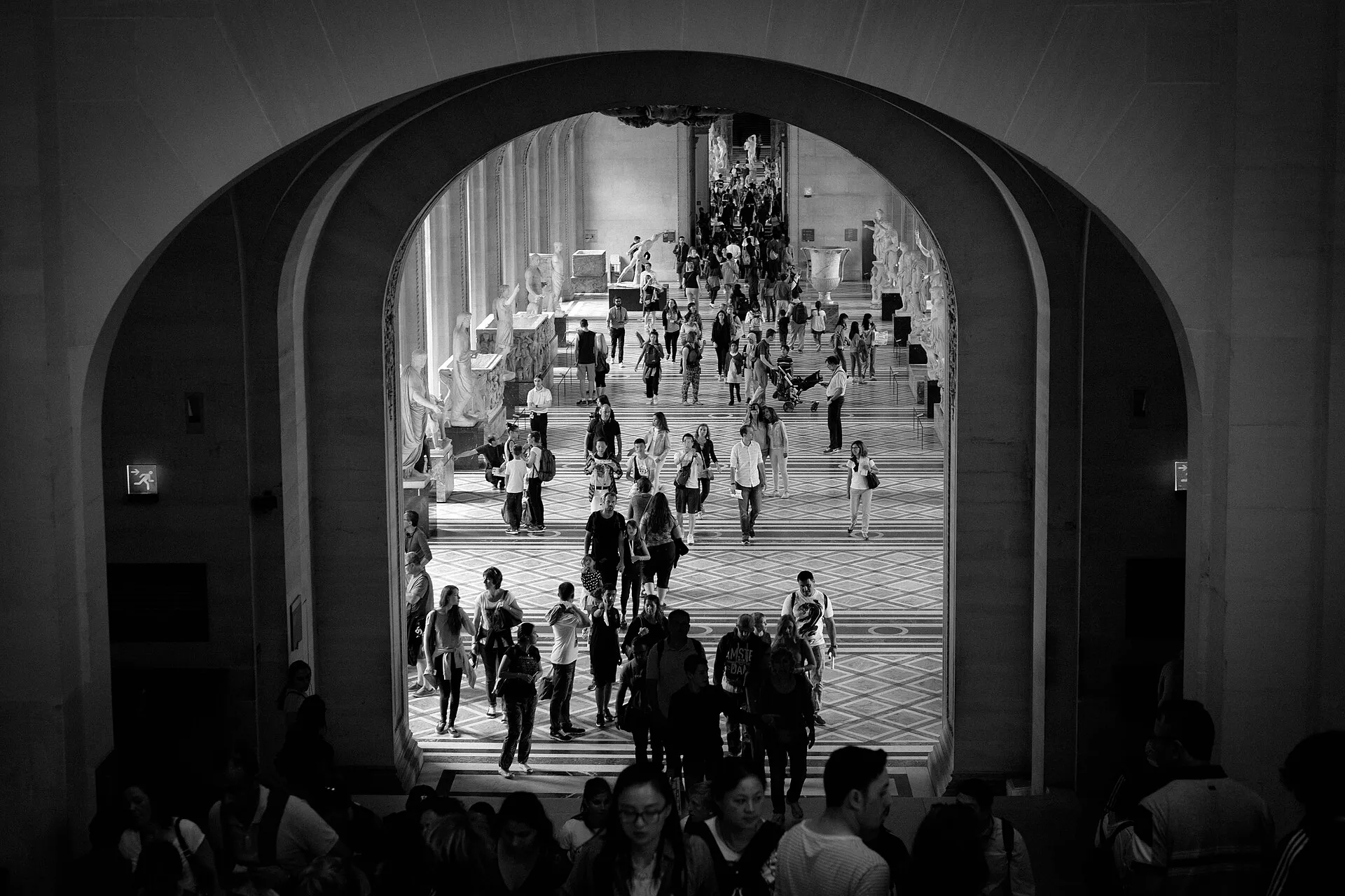 Visitors moving through a busy museum gallery