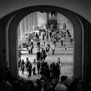 Visitors moving through a busy museum gallery